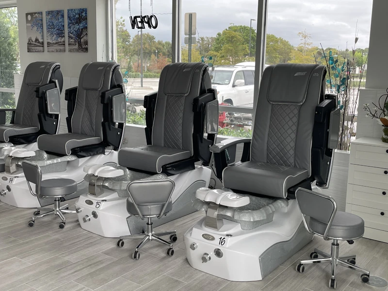 Pedicure chairs beside the salon windows